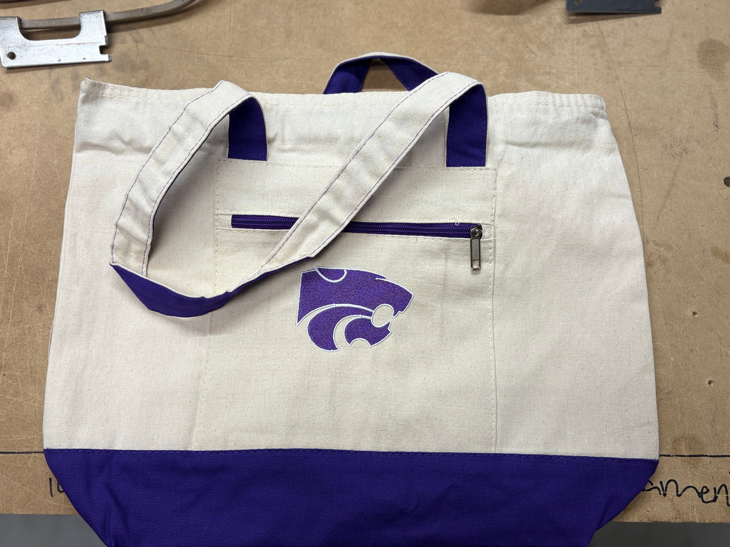 White and blue jacket with a logo on a cardboard surface